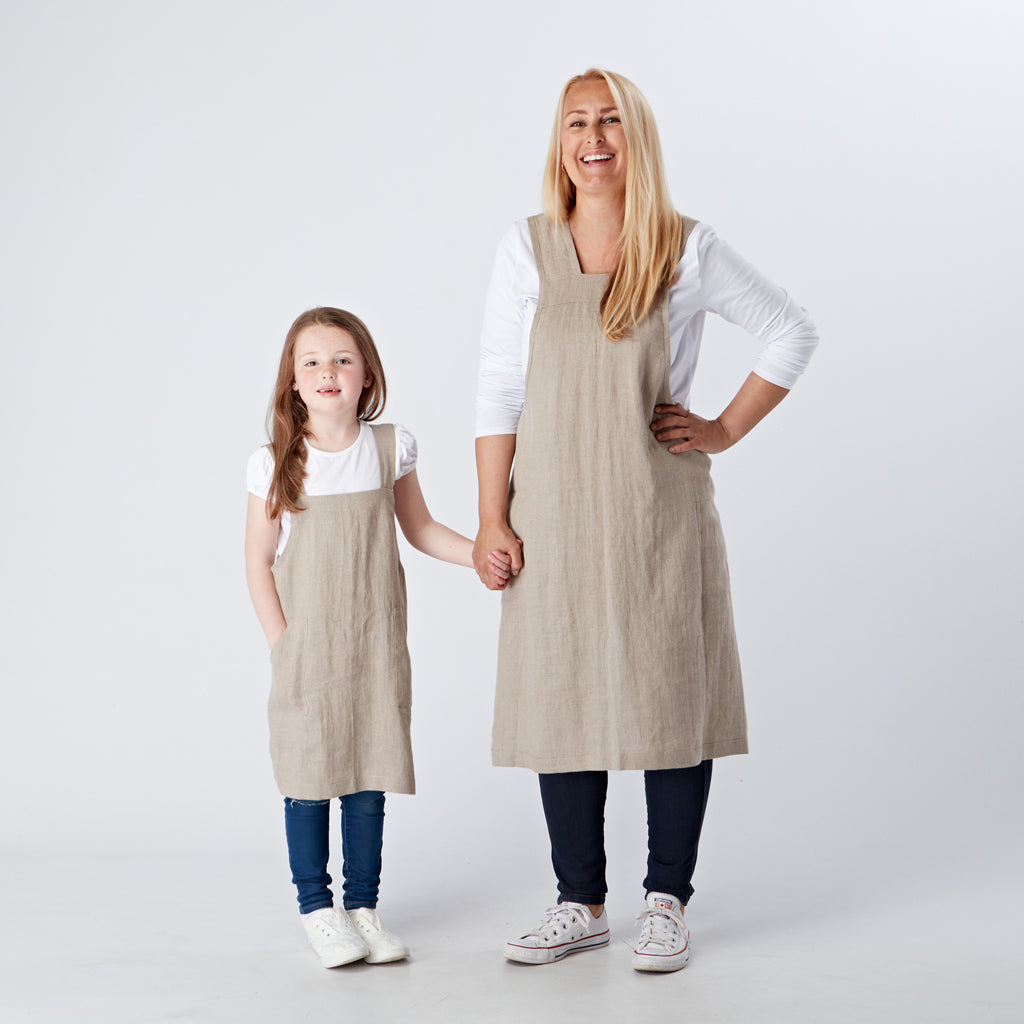 https://linenandfonts.co.uk/cdn/shop/products/pure-linen-mum-and-daughter-apron-set-natural-linen-and-fonts.jpg?v=1653240560
